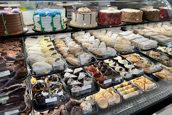 display counter with cakes and pastries at Henris | 56 East Andrews Dr NW, Atlanta, GA 30305