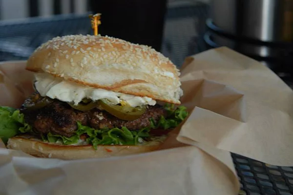 A cheeseburger with jalapenos and other toppings | 259 W Washington St, Athens, GA 30601