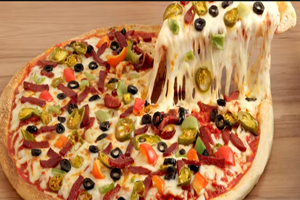 Full pizza pie topped with veggies with a cheesy slice being pulled off the plate | 2240 Barnett Shoals Rd, Athens, GA 30605